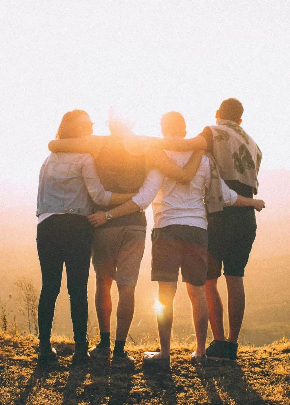 Team hug in sundown.